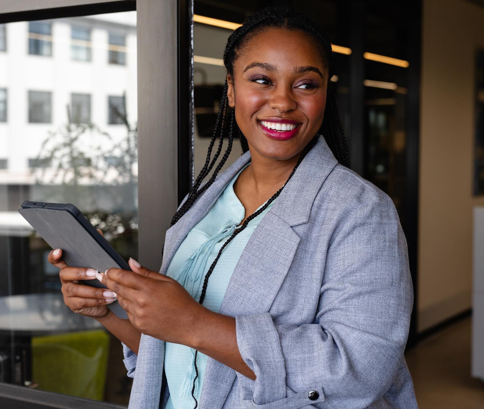 A confident member of the Ardent Africa community holding a tablet