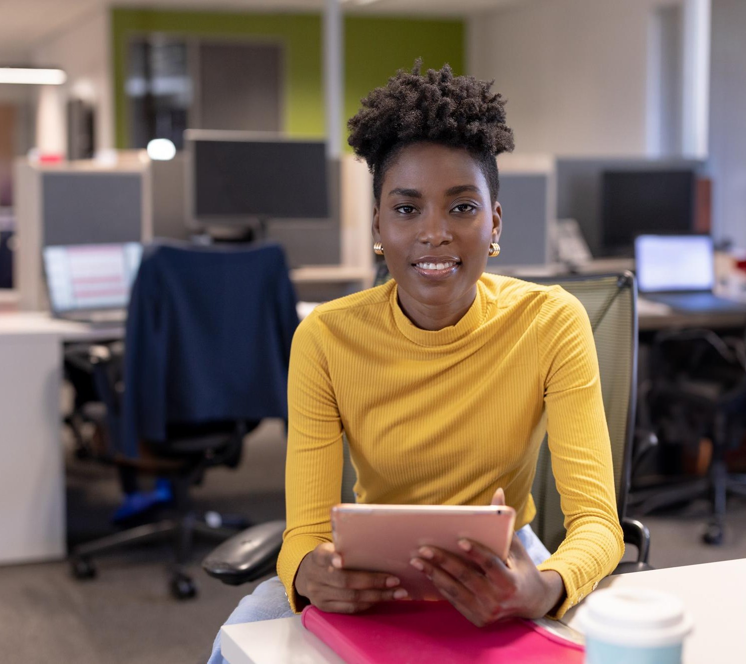 An Ardent Africa team member working at her desk with a tablet